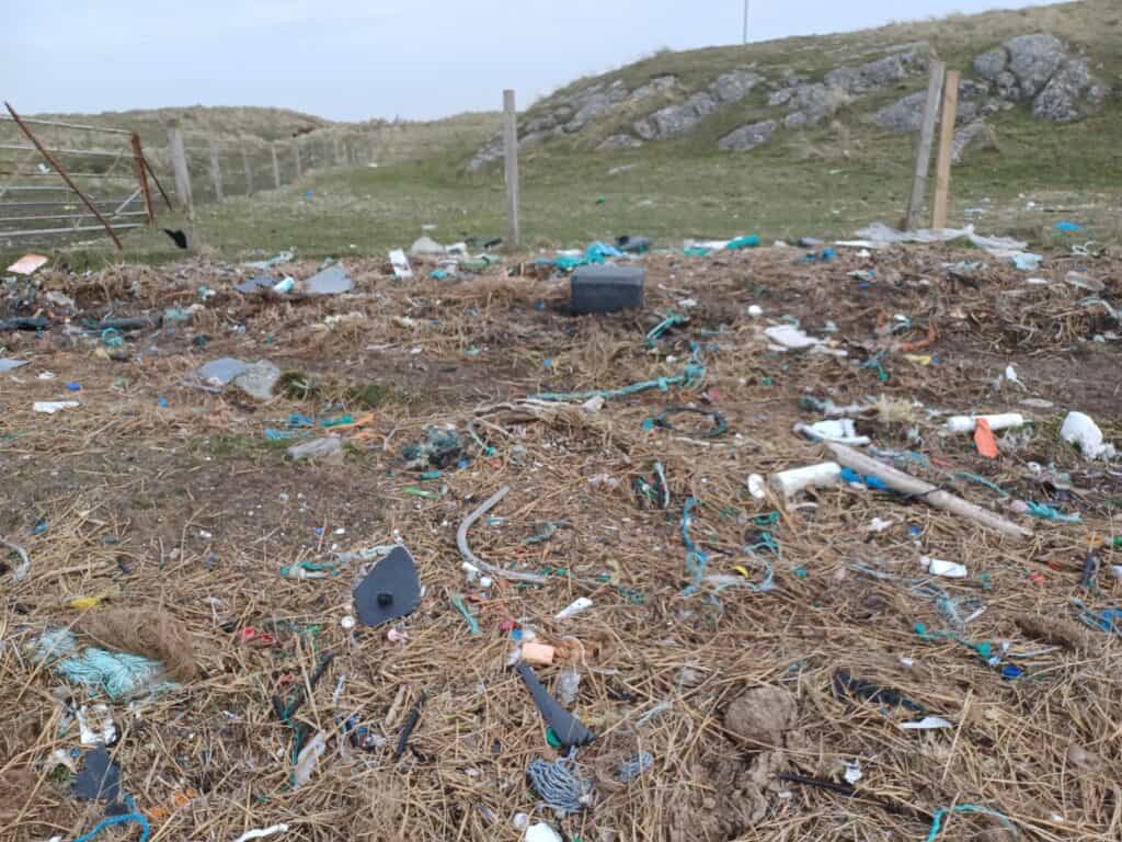 crossapol beach nets and rope buried among the seaweed and marram grass