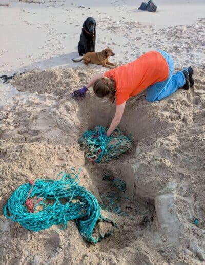 susanne and sonya caennabeinne fishing net buried deep in the sand